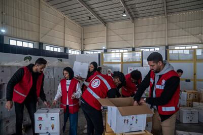 Members of the Egyptian Red Crescent and civil organisations in Rafah preparing the aid for transportation to Gaza. Getty Images
