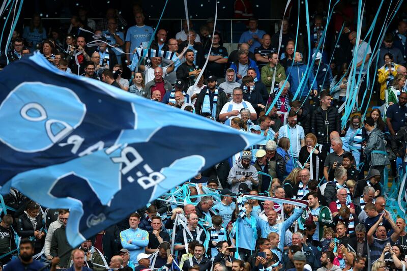 Fans enjoy the atmosphere during the Premier League match between Manchester City and Huddersfield Town at Etihad Stadium. Getty Images