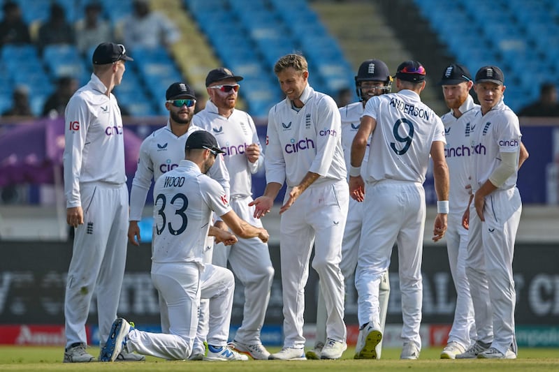 England's Joe Root, centre, celebrates with teammates after taking the wicket of India's Ravindra Jadeja, caught and bowled for 112. AFP
