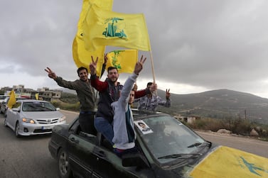 Supporters of Lebanon's Hezbollah leader Sayyed Hassan Nasrallah gesture as they hold Hezbollah flags in Marjayoun. Reuters
