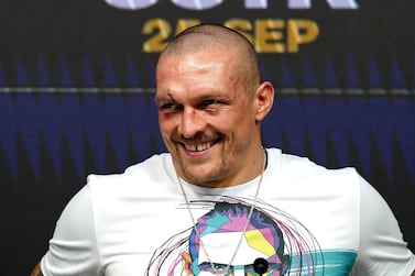 Oleksandr Usyk of Ukraine smiles during a press conference after winning the WBA (Super), WBO and IBF boxing title bout against Anthony Joshua of Britain at the Tottenham Hotspur Stadium in London Saturday Sept.  25, 2021.  (Nick Potts / PA via AP)