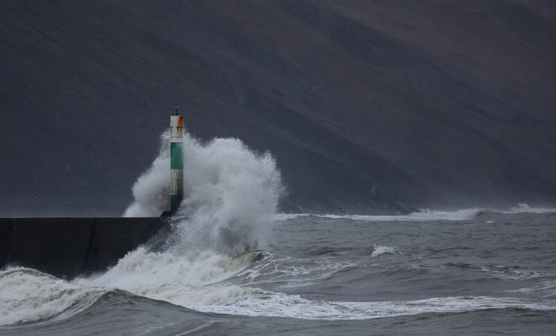Waves hit the harbour wall during strong winds in Aberystwyth, in Wales. Reuters