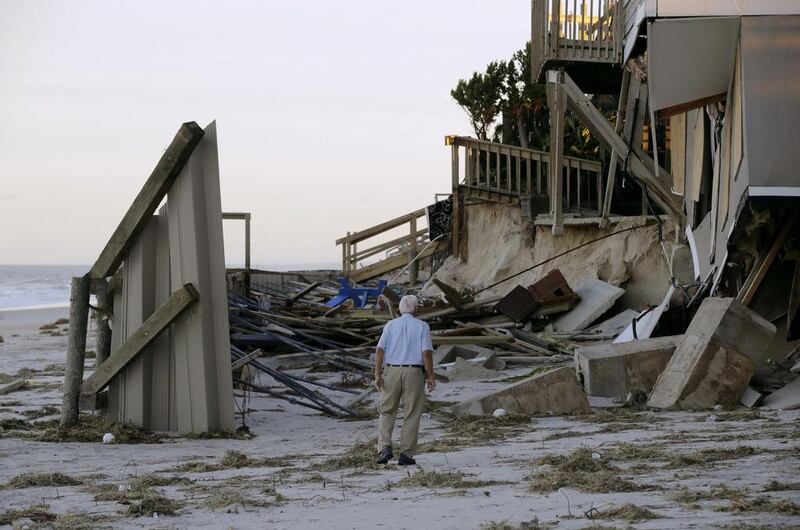 HV Bailey looks at damage to a neighbour’s home at Ponte Vedra Beach, Florida. Charlie Riedel / AP Photo