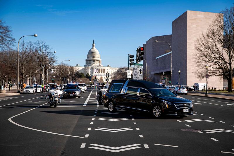 A hearse carries the casket of US Capitol Police Officer Brian Sicknick on January 10, 2021, during a police procession in Washington.  AFP