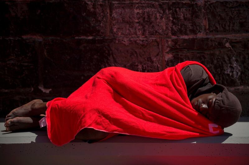 A man wrapped in a Red Cross blanket sleeps after arriving aboard a coast guard boat at the harbour of Tarifa, after an inflatable boat carrying 135 migrants was rescued by the Spanish coast guard in the Mediterranean. Jorge Guerrero/AFP