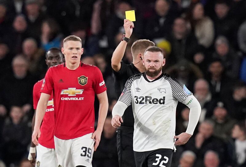 Wayne Rooney is shown a yellow card by referee Craig Pawson. Reuters