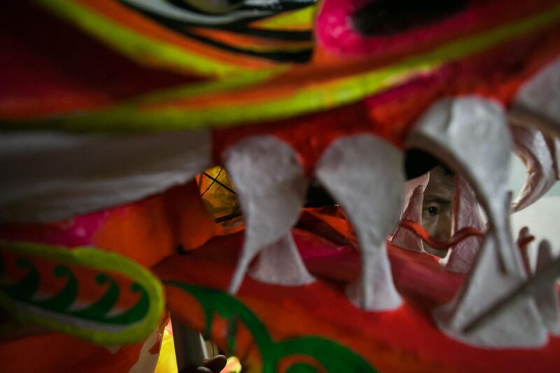 A lion dancer prepares to perform for Lunar New Year festivities in Yangon, Myanmar. AFP