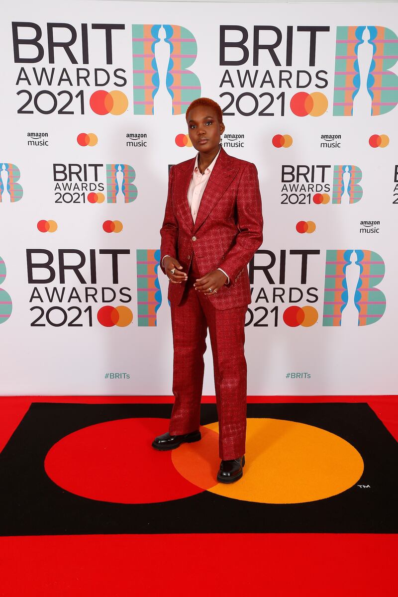Singer Arlo Parks wore a deep red tailored suit to collect her award for British Breakthrough Artist. AFP