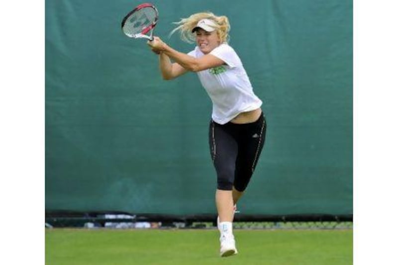Caroline Wozniacki finally made it on to the grass at Wimbledon to practise yesterday.