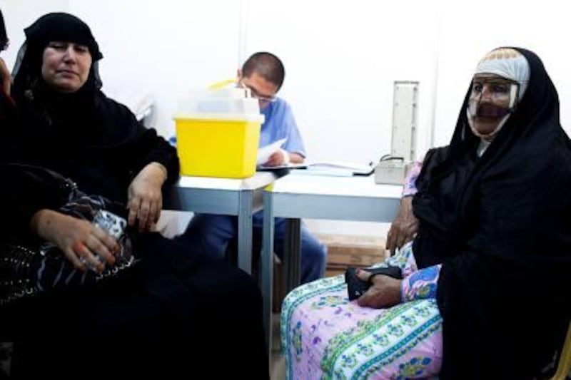 12/10/10 - Abu Dhabi, UAE - Amena Mohamed, 51 and Fatemeh Nejad, 72, left to right, have their blood pressure checked as Red Crescent launched a campaign in Al Marfa in the Western Region to run free clinics for people to be tested for diabetes and breast cancer along with other medical conditions on Tuesday October 12, 2010.  (Andrew Henderson / The National)
