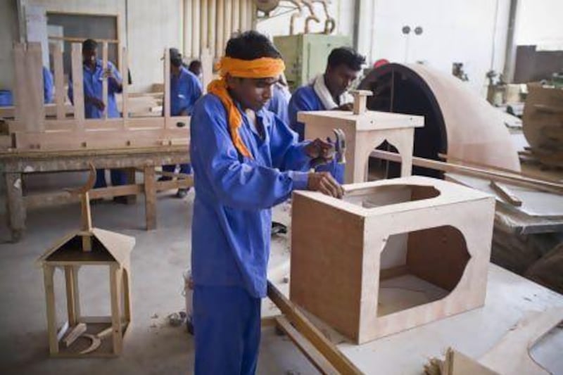 Anil Kumar, a carpenter, works on an Extra Co prefab mosque. Antonie Robertson / The National