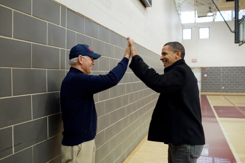 Mr Obama and Mr Biden high-five after watching Sasha Obama and Maisy Biden, the vice president's granddaughter, play in a basketball game in Chevy Chase, Maryland, February 27, 2010. Photo: The National Archives