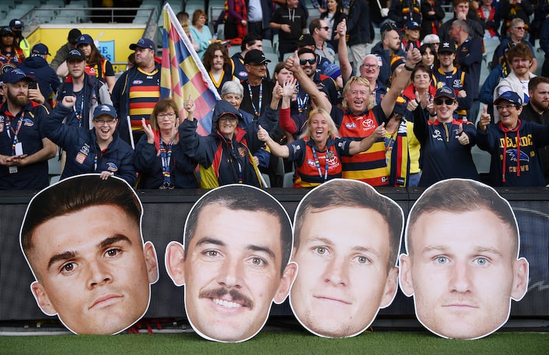 Crows fans celebrate a win during the round four AFL match between Adelaide Crows and Fremantle Dockers at Adelaide Oval in Adelaide, Australia. Getty 