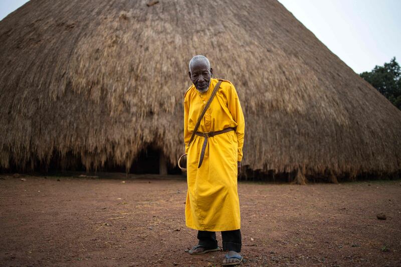 The traditional guard in front of one of the buildings of the Kasubi Royal Tombs in Kampala. 