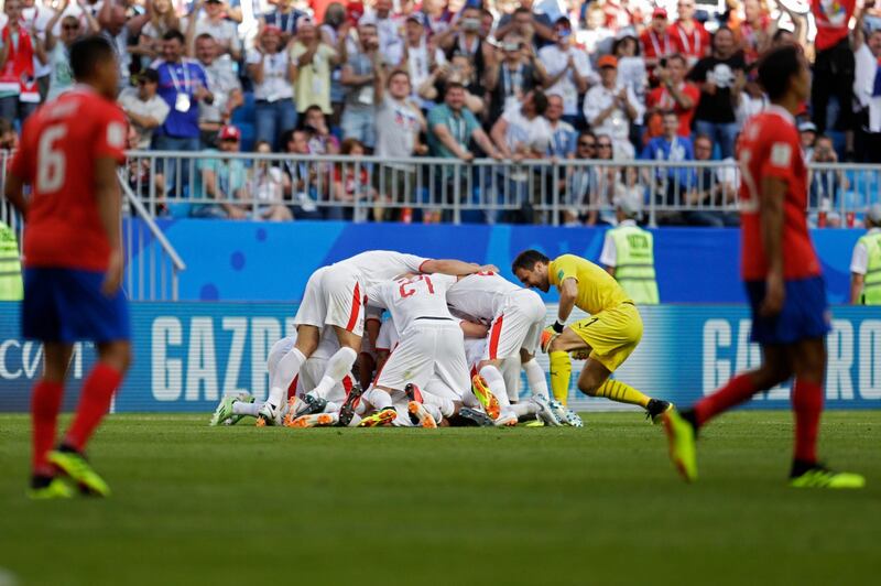 Serbian players celebrate their first goal during the group E match. Natacha Pisarenko / AP Photo