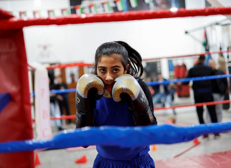 A Palestinian girl, Farah Abu Al-Qomsan, 15, warms up during training inside the first women boxing center in Gaza City January 17, 2023.   REUTERS / Mohammed Salem