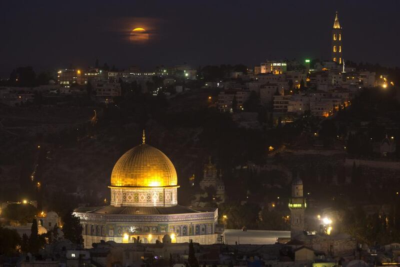The supermoon shines over the Old city of Jerusalem. Jim Hollander / EPA