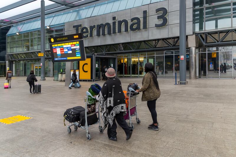 Passengers arrive at London's Heathrow Airport. The business posted a loss of £139 million in the first half of the year. Getty