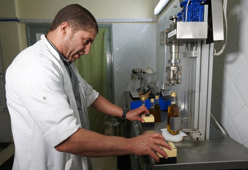 A technician woks on bottles of argan oil, at Women's Agricultural Cooperative Taitmatine, in Tiout, near Taroudant, Morocco June 10, 2021. Picture taken June 10, 2021. REUTERS/Abdelhak Balhaki