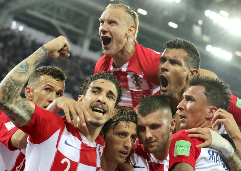 epa06814462 Luka Modric (C) of Croatia celebrates with teammates after scoring the 2-0 lead from the penalty spot during the FIFA World Cup 2018 group D preliminary round soccer match between Croatia and Nigeria in Kaliningrad, Russia, 16 June 2018.

(RESTRICTIONS APPLY: Editorial Use Only, not used in association with any commercial entity - Images must not be used in any form of alert service or push service of any kind including via mobile alert services, downloads to mobile devices or MMS messaging - Images must appear as still images and must not emulate match action video footage - No alteration is made to, and no text or image is superimposed over, any published image which: (a) intentionally obscures or removes a sponsor identification image; or (b) adds or overlays the commercial identification of any third party which is not officially associated with the FIFA World Cup)  EPA/ARMANDO BABANI   EDITORIAL USE ONLY