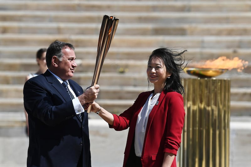Spyros Capralos, president of the Hellenic Olympic Committee, with former Japanese swimmer Naoko Imoto. EPA