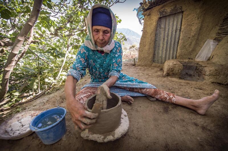 Moroccan potter Fatima Harama from the M'tioua tribe works on pottery near the village of Ourtzagh, Morocco. AFP
