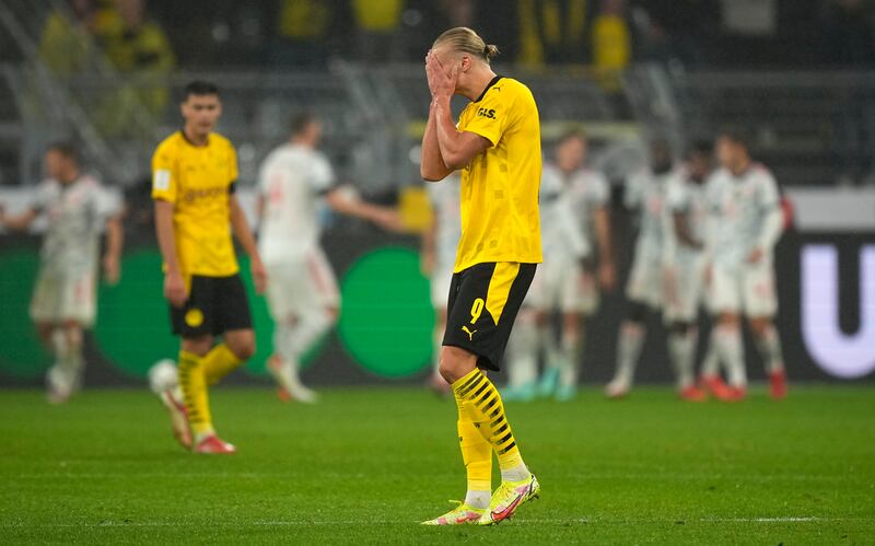 Dortmund's Erling Braut Haaland reacts after Robert Lewandowski opened the scoring for Bayern.