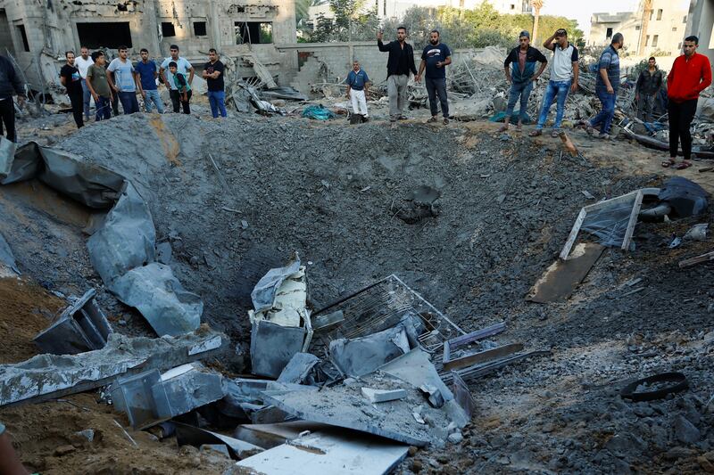 Palestinians survey the rubble of a house destroyed in Israeli strikes in Khan Younis, in the southern Gaza Strip. Reuters