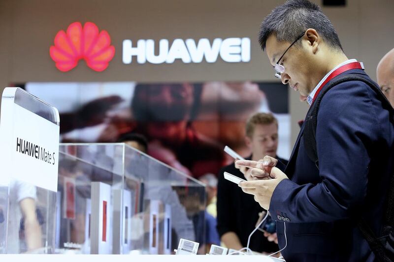 Visitors to the IFA consumer electronics trade fair in Berlin try out the Huawei Mate S smartphone at the company’s stand. Sean Gallup / Getty Images  