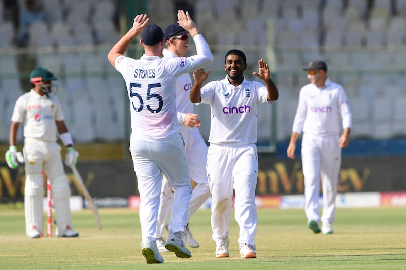 England captain Ben Stokes congratulates Rehan Ahmed after he took the wicket of Pakistan's Babar Azam for 54. AFP