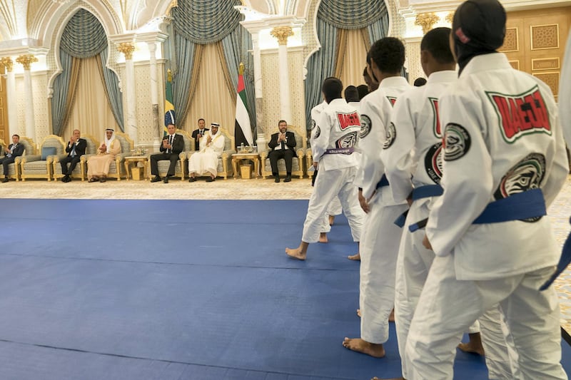 ABU DHABI, UNITED ARAB EMIRATES - October 27, 2019: HH Sheikh Mohamed bin Zayed Al Nahyan, Crown Prince of Abu Dhabi and Deputy Supreme Commander of the UAE Armed Forces and HE Jair Bolsonaro, President of Brazil (back centre), watch a Jiu Jitsu display during an official reception at Qasr Al Watan.

( Eissa Al Hammadi for the Ministry of Presidential Affairs )
---