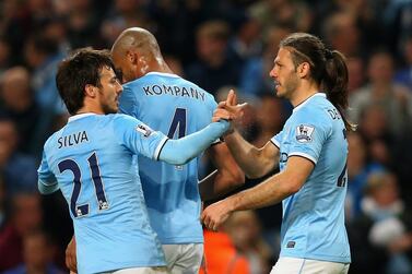 Martin Demichelis of Manchester City, right, celebrates with David Silva and Vincent Kompany as he scores their third goal on Monday night. Alex Livesey / Getty Images / April 21, 2014