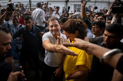 Congress Party leader Rahul Gandhi, centre, greets a supporter as he leaves the party headquarters with his sister and party leader Priyanka Gandhi Vadra, in New Delhi. AP