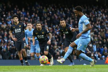 Manchester City's English midfielder Raheem Sterling (R) takes a penalty and scores his team's opening goal during the English Premier League football match between Manchester City and Wolverhampton Wanderers at the Etihad Stadium in Manchester, north west England, on December 11, 2021.  (Photo by NIGEL RODDIS / AFP) / RESTRICTED TO EDITORIAL USE.  No use with unauthorized audio, video, data, fixture lists, club/league logos or 'live' services.  Online in-match use limited to 120 images.  An additional 40 images may be used in extra time.  No video emulation.  Social media in-match use limited to 120 images.  An additional 40 images may be used in extra time.  No use in betting publications, games or single club/league/player publications.   /  