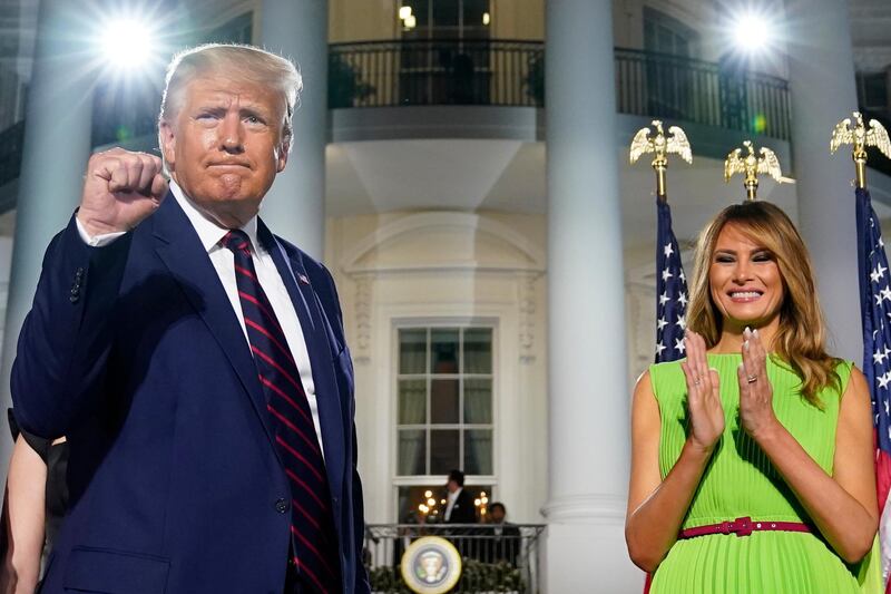 President Donald Trump and first lady Melania Trump stand on the South Lawn of the White House on the fourth day of the Republican National Convention, Thursday, Aug. 27, 2020, in Washington. (AP Photo/Evan Vucci)