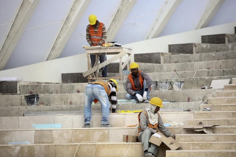 Above, workers build a staircase on a building at the King Abdullah Financial District in Riyadh, Saudi Arabia. Simon Dawson / Bloomberg