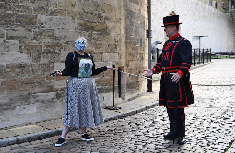 A visitor speaks with Yeoman Warder at the Tower of London. EPA