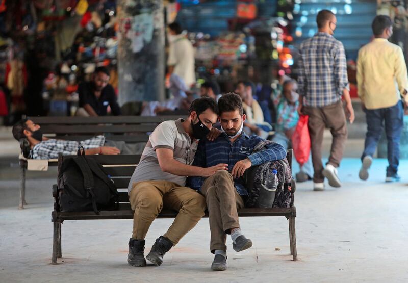 People waits for transportation at a bus station in Jammu, India. AP Photo