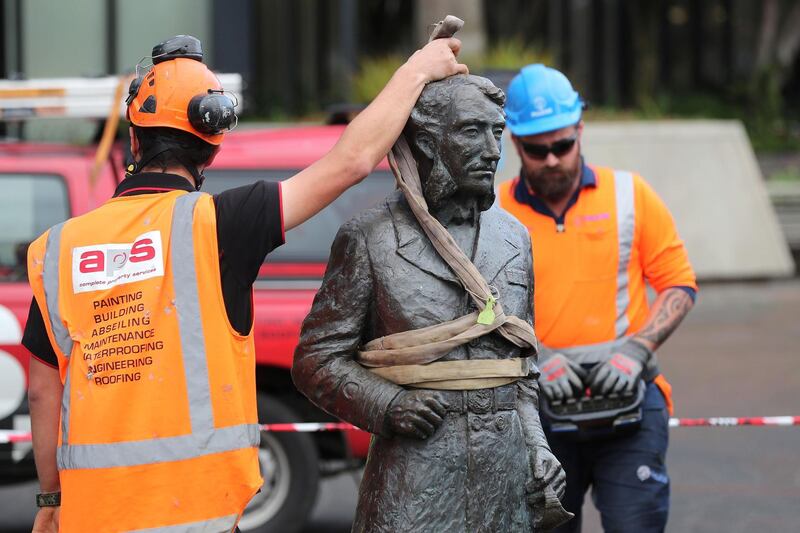 Workers remove a controversial statue of Captain John Fane Charles Hamilton from Civic Square in Hamilton, New Zealand on June 12, following a formal request by the Waikato-Tainui iwi (tribal confederation) and threats it would be torn down during a Black Lives Matter march due to take place the following day. The statue of Hamilton, a British military commander who led a detachment against Maori during the Battle of Gate Pa in 1864, was removed as statues of colonial figures in Britain, Belgium and the US were toppled by demonstrators amid worldwide protests.  Michael Bradley / AFP