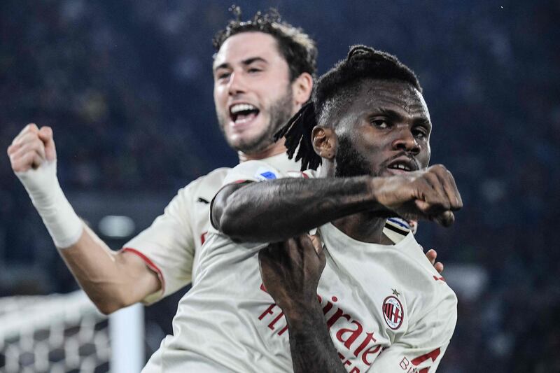 AC Milan's Ivorian midfielder Franck Kessie (R) celebrates after scoring a penalty. AFP