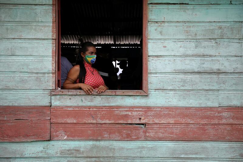 An Indigenous woman waits to receive the Sinovac's Covid-19 vaccine at Sao Jose Village in Itacoatiara, Amazonas state, Brazil. Reuters