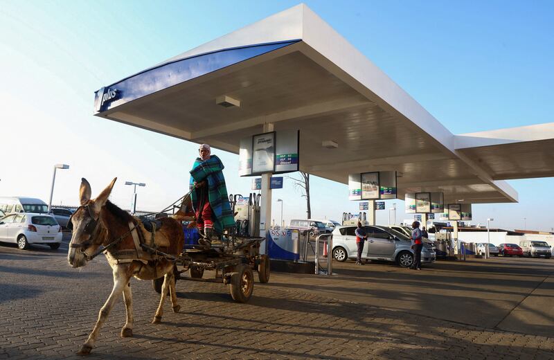 A man leaves a petrol station after checking the tyre pressure on his donkey cart in Soweto, Johannesburg. Reuters