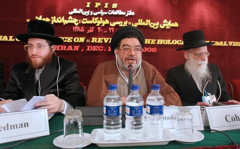 FILEâ€” In this Dec. 11, 2006, file photo, top cleric Ali Akbar Mohtashamipour, center, speaks during a conference on the Holocaust with Rabbi Moishe Arye Friedman, left, from Austria, and Rabbi Ahron Cohen, right, from England, in Tehran, Iran. Mohtashamipour, a Shiite cleric who as Iran's ambassador to Syria helped found the Lebanese militant group Hezbollah and lost his right hand to a book bombing reportedly carried out by Israel, died Monday, June 7, 2021, of the coronavirus. (AP Photo/Vahid Salemi, File)