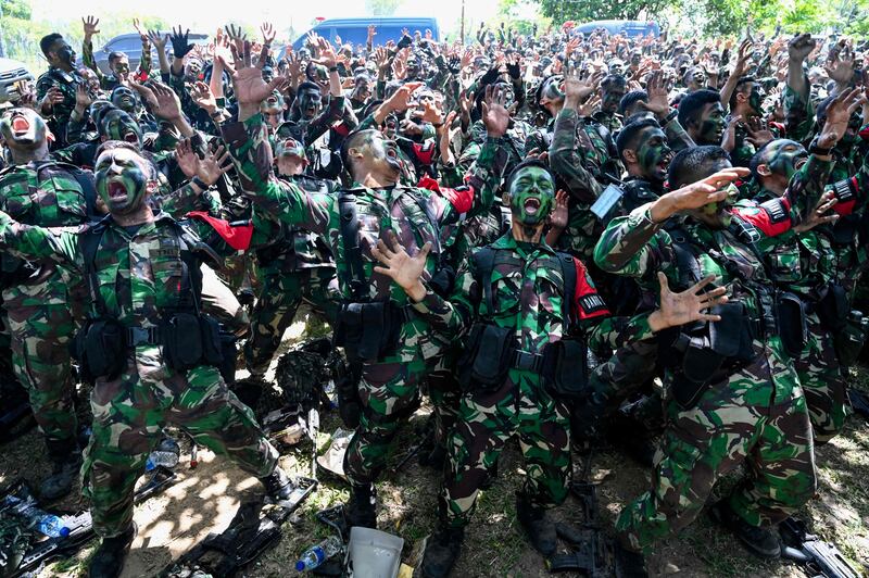 Soldiers from the Iskandar Muda military command sing after exercises in Indonesia. AFP