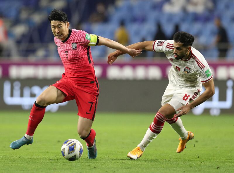 South Korea's Son Heung-min holds off the challenge of Majed Hassan of the UAE. Reuters