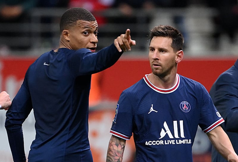 Paris Saint-Germain's French forward Kylian Mbappe talks to Paris Saint-Germain's Argentinian forward Lionel Messi at the end of the French L1 football match between Stade de Reims and Paris Saint-Germain at Auguste Delaune Stadium in Reims on August 29, 2021. AFP
