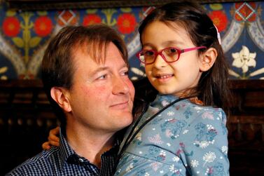 Richard Ratcliffe, the husband of jailed British-Iranian aid worker Nazanin Zaghari-Ratcliffe, sits with his daughter Gabriella during a press conference in London. Reuters