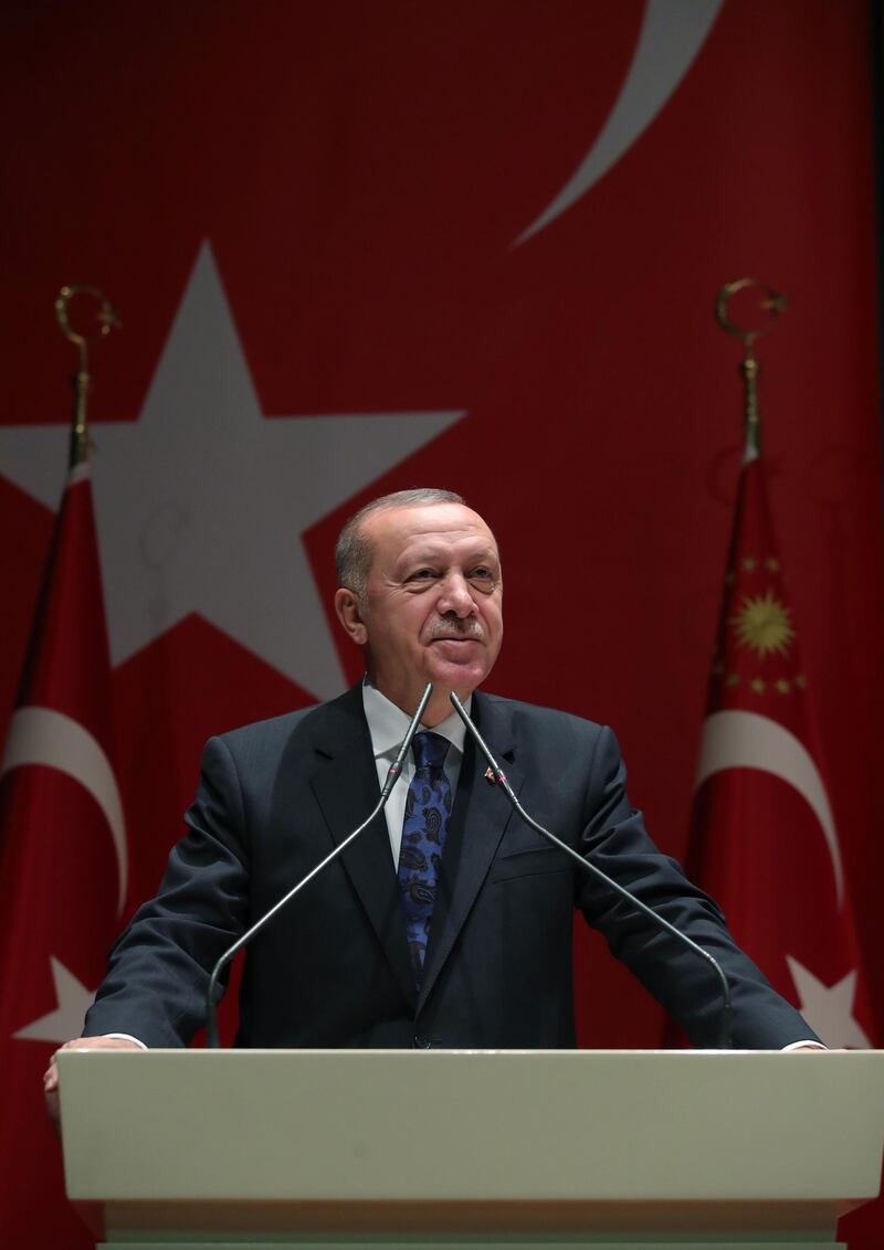 A hand out image made available by the Turkish Presidential Press Service on December 26, 2019, shows Turkey's President Recep Tayyip Erdogan speaking in Ankara, on December 26, 2019.  The Turkish parliament will in January 2020 vote on a motion to send troops to Syria to support the UN-backed government in Tripoli, President Recep Tayyip Erdogan said. "We will present the motion to send troops (to Libya) as soon as parliament resumes" on January 7, Erdogan said in a speech in Ankara.  - RESTRICTED TO EDITORIAL USE - MANDATORY CREDIT "AFP PHOTO /TURKISH PRESIDENTIAL PRESS SERVICE" - NO MARKETING - NO ADVERTISING CAMPAIGNS - DISTRIBUTED AS A SERVICE TO CLIENTS
 / AFP / TURKISH PRESIDENTIAL PRESS SERVICE / MURAT KULA / RESTRICTED TO EDITORIAL USE - MANDATORY CREDIT "AFP PHOTO /TURKISH PRESIDENTIAL PRESS SERVICE" - NO MARKETING - NO ADVERTISING CAMPAIGNS - DISTRIBUTED AS A SERVICE TO CLIENTS
