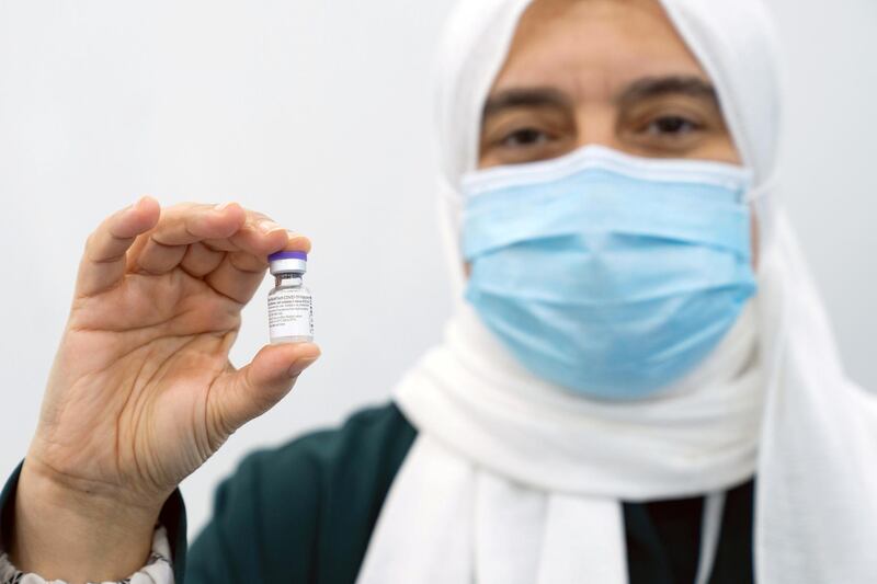 Nourah Abdulla, head of the infectious control centre at Al Jaber Hospital, holds a vial of a Covid-19 vaccine in Kuwait City, Kuwait. Reuters