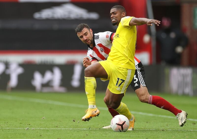 Fulham's Ivan Cavaleiro, right, duels for the ball with Sheffield United's Enda Stevens during the English Premier League soccer match between Sheffield United and Fulham at Bramall Lane stadium in Sheffield, England, Sunday, Oct. 18, 2020. (Carl Recine/Pool via AP)